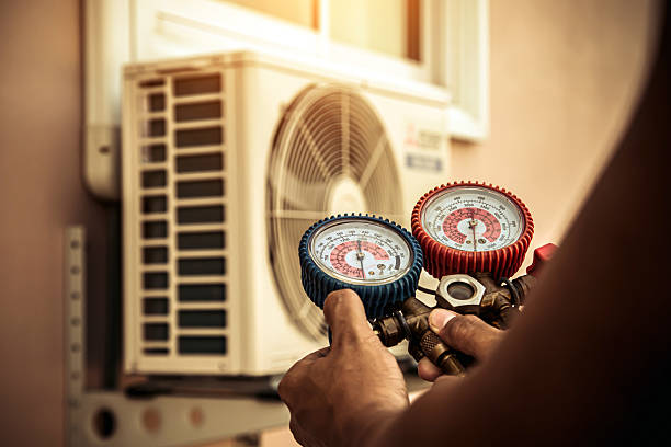 Professional Air Conditioning Service technician working in Hooper, UT